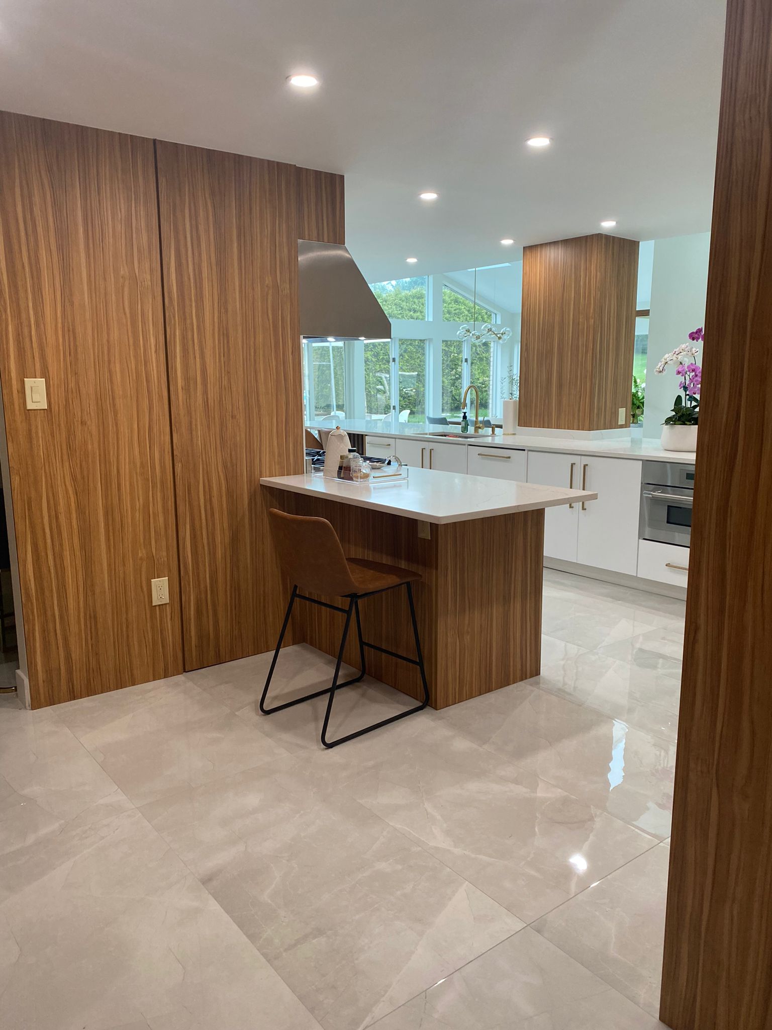 A custom kitchen transformation featuring two-tone cabinetry, quartz countertops, and porcelain tile flooring designed for modern living.