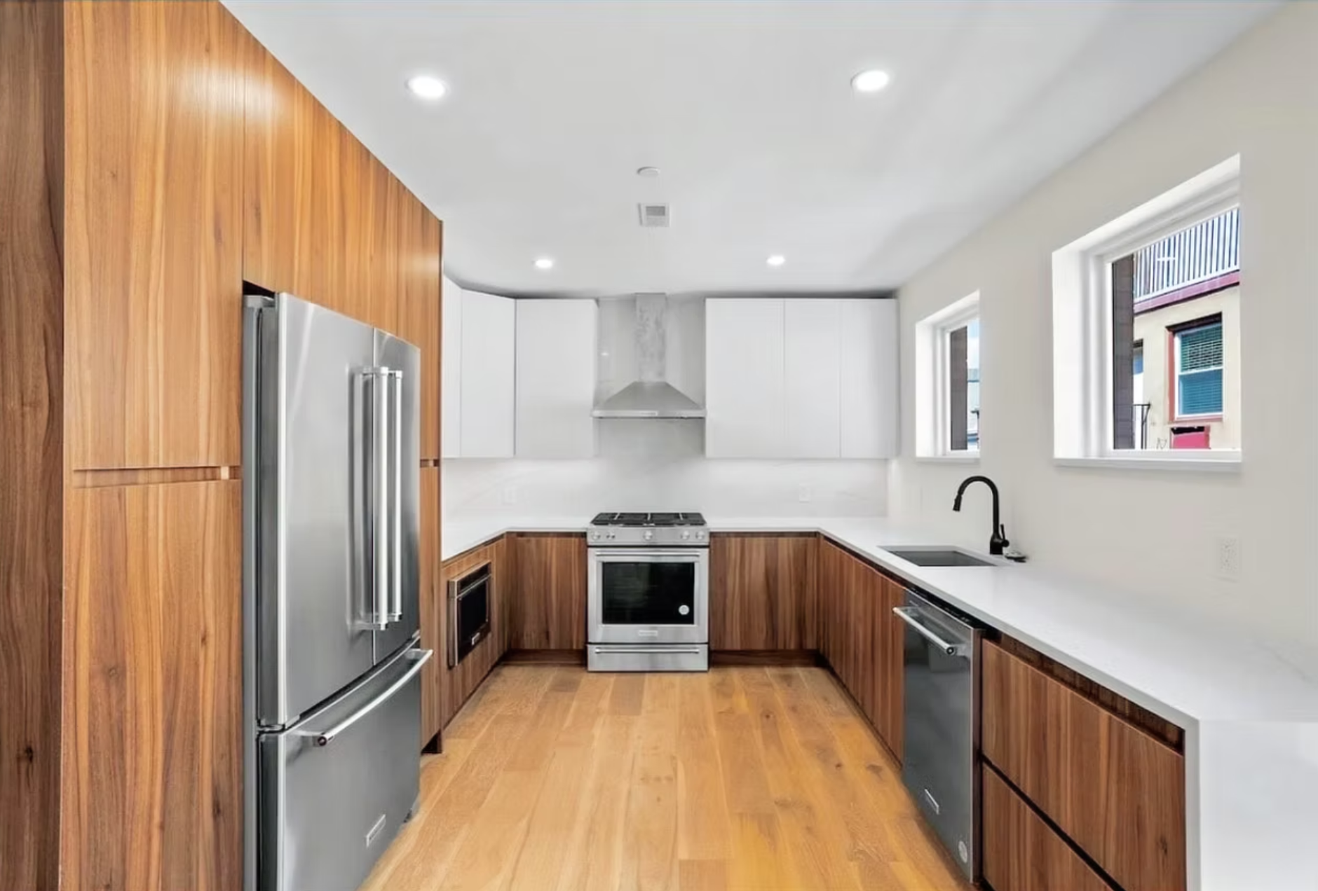 A two-tone kitchen designed for a Philadelphia residential development with clean lines, functional storage, and timeless finishes